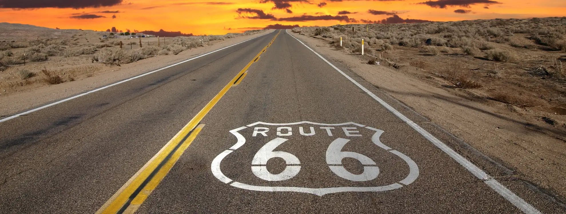 Historic Route 66 highway shield painted on the road at sunset, representing the classic Victorville, CA real estate lifestyle.